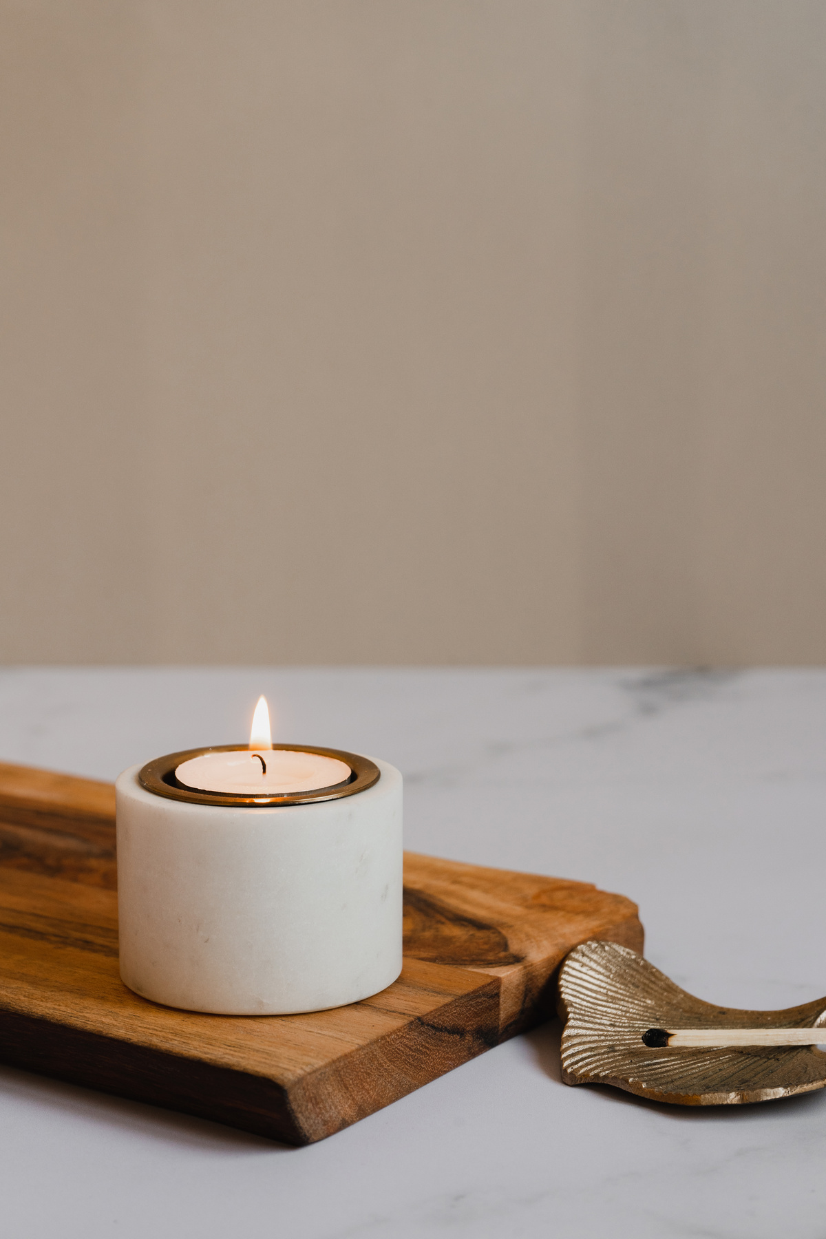 Lighted Candle on Wooden Board